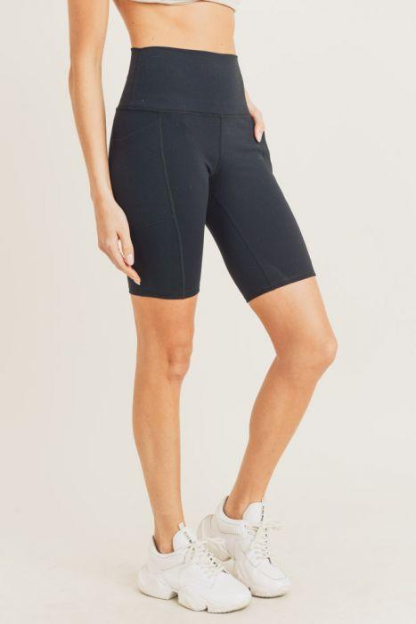 A pair of Tapered Band Essential Bermuda Highwaist Leggings in a stylish design, featuring a high waistband and deep side pockets, perfect for workouts and casual wear.