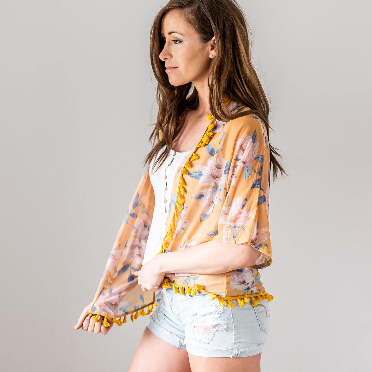 A stylish tassel trim kimono with a floral motif, perfect for spring and summer layering.