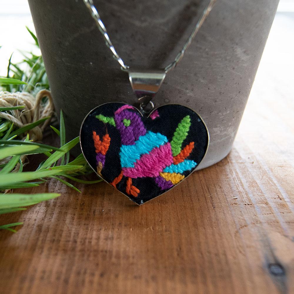 Colorful Tenango de Doria Embroidered Heart Necklace with unique Otomi embroidery on aluminum pendant.