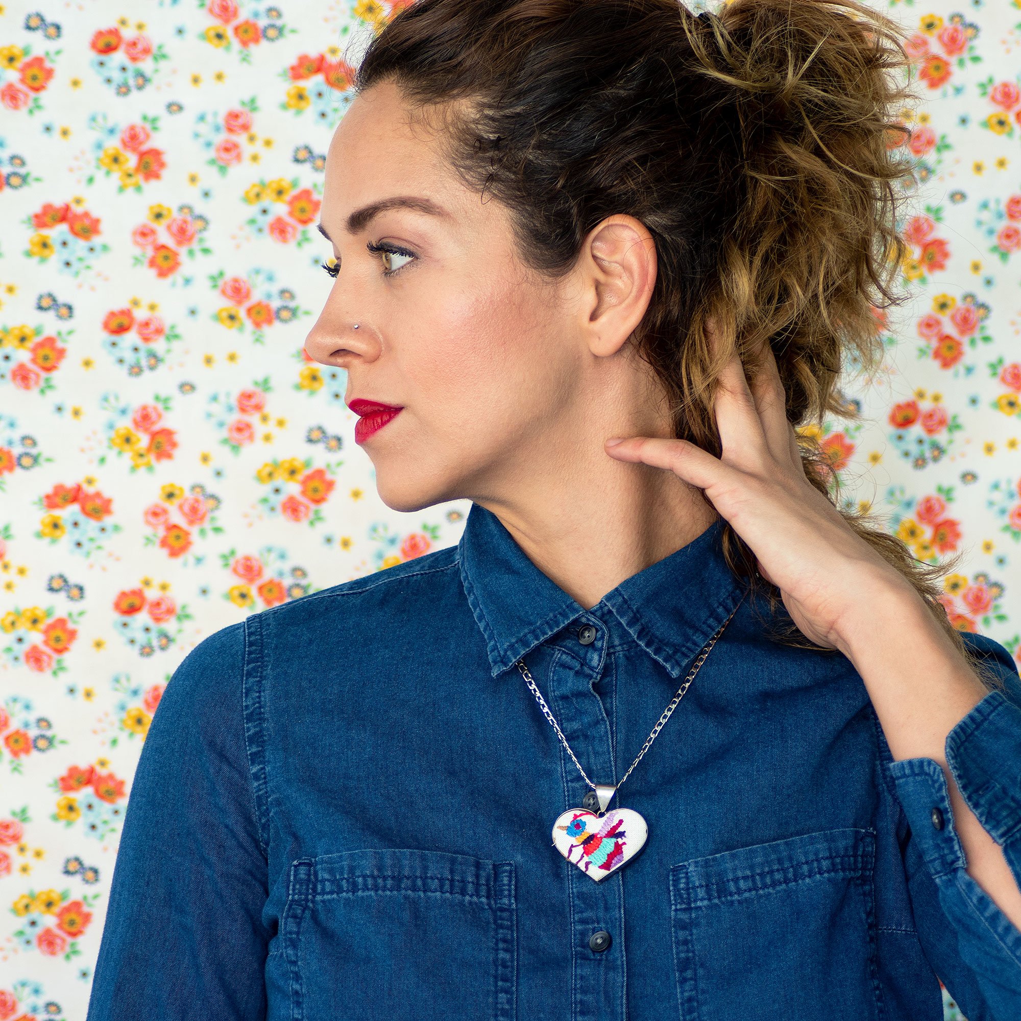 Colorful Tenango de Doria Embroidered Heart Necklace with unique Otomi embroidery on aluminum pendant.