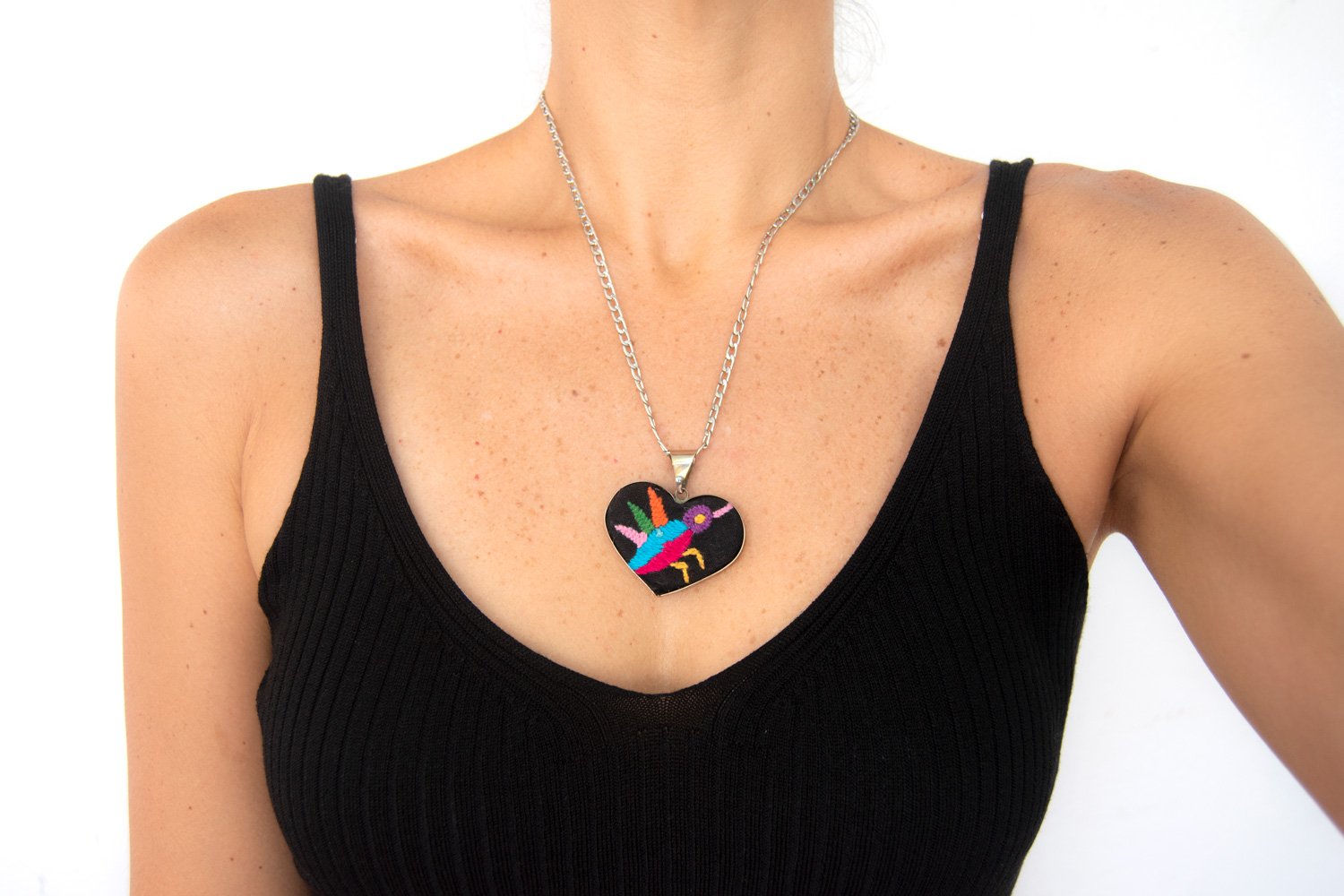 Colorful Tenango de Doria Embroidered Heart Necklace with unique Otomi embroidery on aluminum pendant.