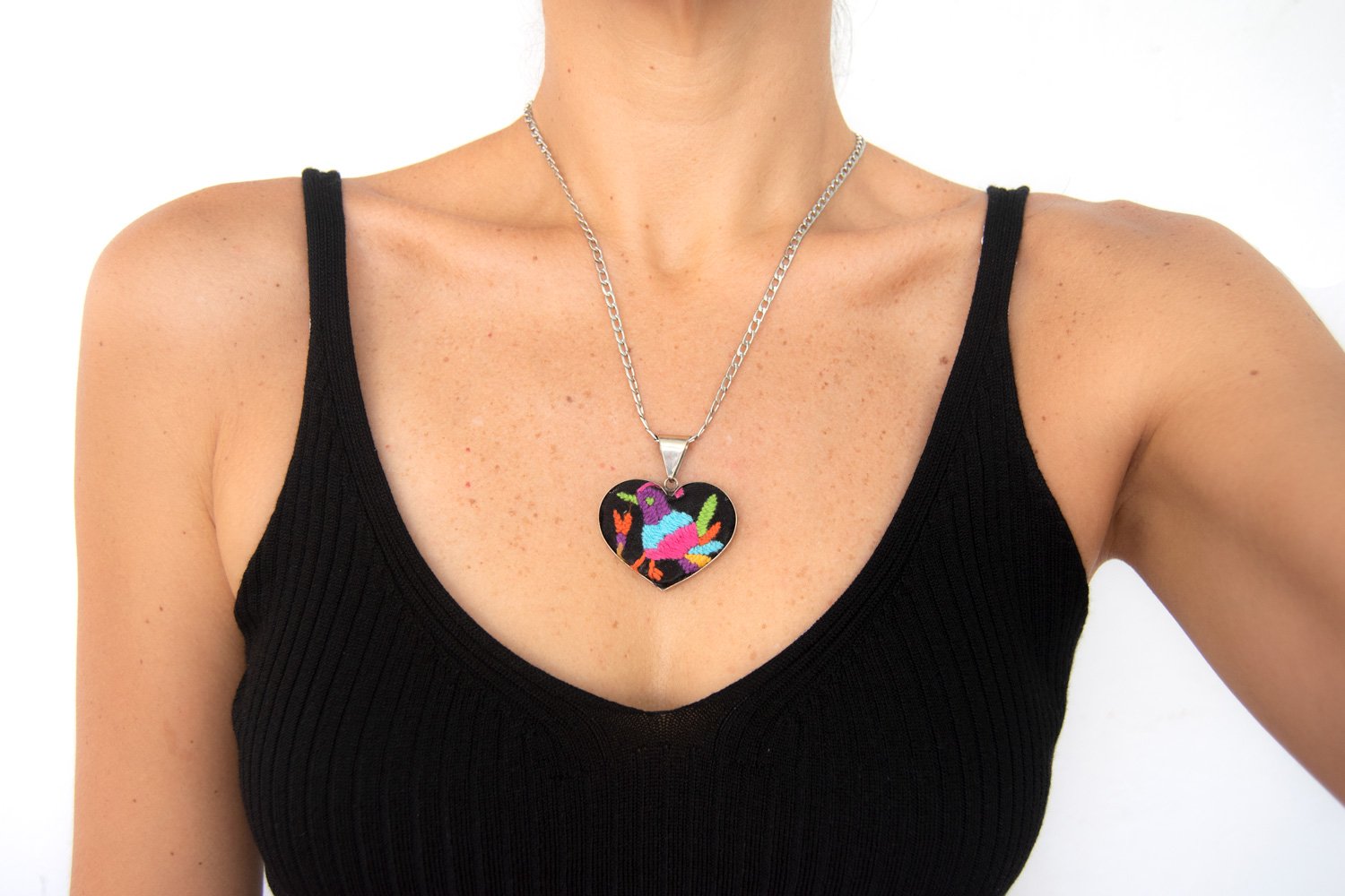 Colorful Tenango de Doria Embroidered Heart Necklace with unique Otomi embroidery on aluminum pendant.