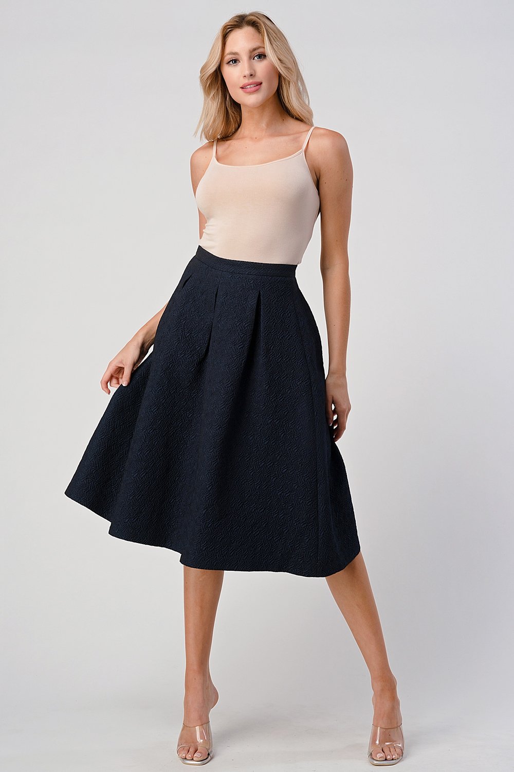 A stylish Pleated Waist Mid-Length Puffy Skirt displayed on a model, showcasing its elegant pleats and puffy silhouette.