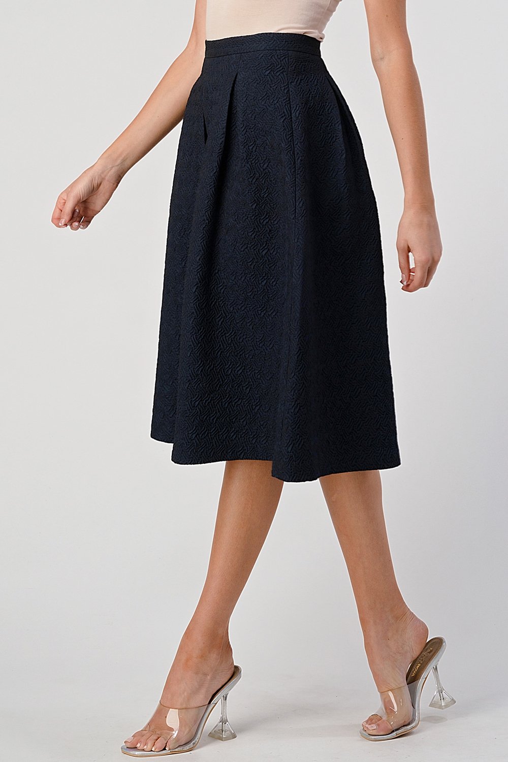 A stylish Pleated Waist Mid-Length Puffy Skirt displayed on a model, showcasing its elegant pleats and puffy silhouette.