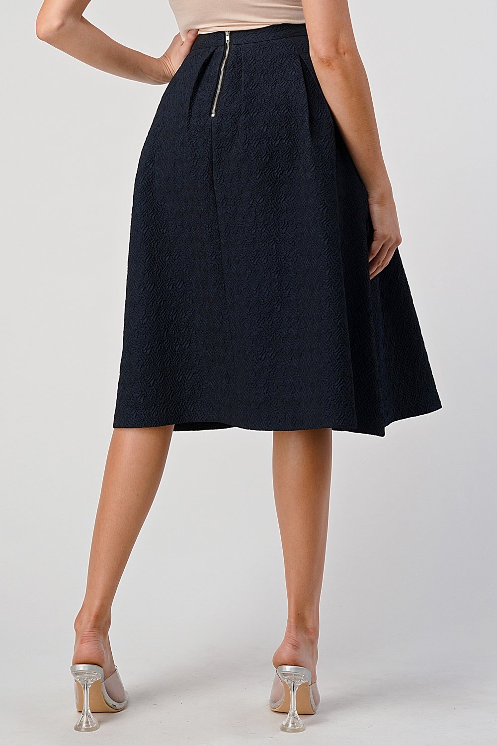 A stylish Pleated Waist Mid-Length Puffy Skirt displayed on a model, showcasing its elegant pleats and puffy silhouette.