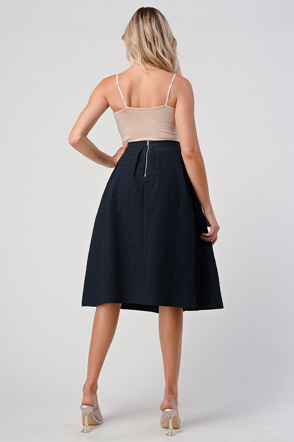 A stylish Pleated Waist Mid-Length Puffy Skirt displayed on a model, showcasing its elegant pleats and puffy silhouette.