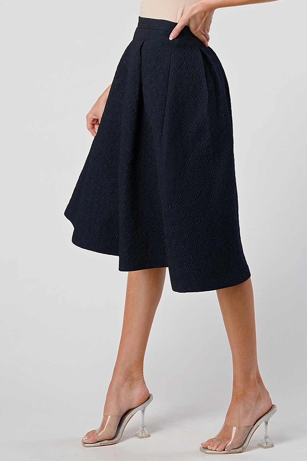 A stylish Pleated Waist Mid-Length Puffy Skirt displayed on a model, showcasing its elegant pleats and puffy silhouette.