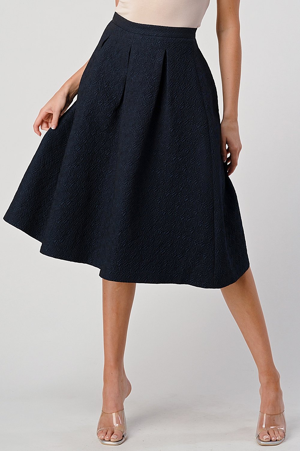 A stylish Pleated Waist Mid-Length Puffy Skirt displayed on a model, showcasing its elegant pleats and puffy silhouette.