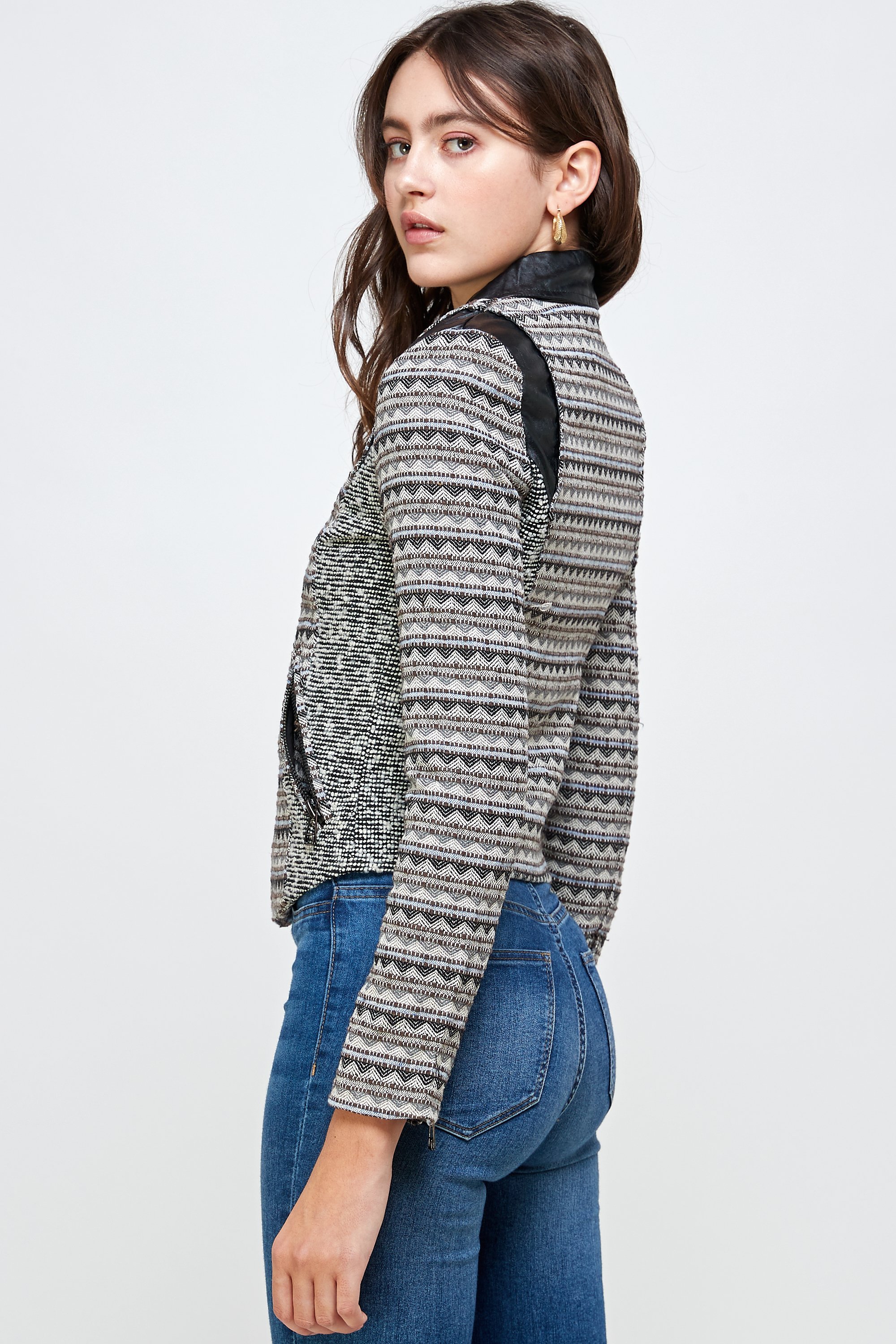 A stylish Jacquard Biker Jacket Top displayed on a mannequin, showcasing its intricate fabric design and tailored fit.