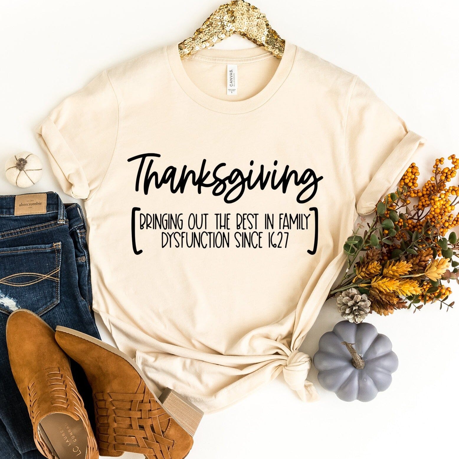 A cozy Thanksgiving Dysfunction Tee featuring humorous design, perfect for holiday gatherings.