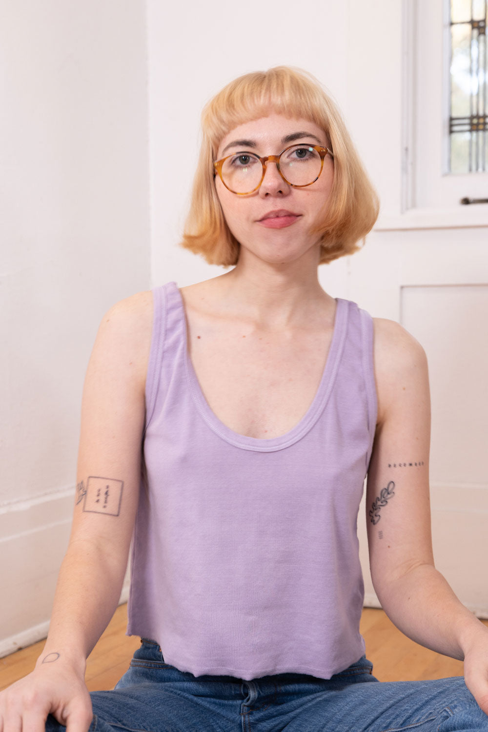 A stylish 90s-inspired tank top made from 100% organic cotton, showcasing its casual and timeless design.