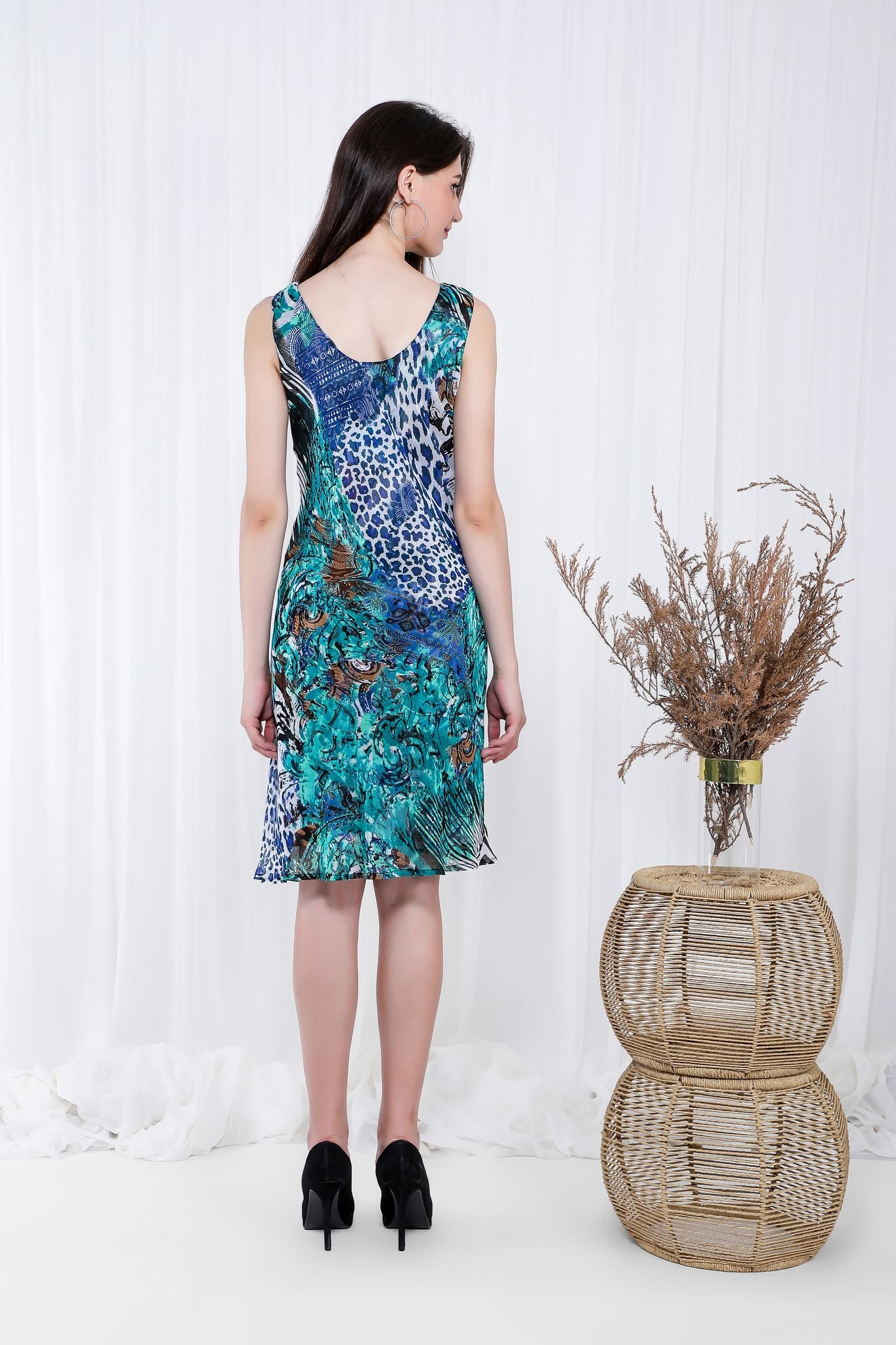The Bali Feels Reversible Dress displayed in various colors, showcasing its versatile design and cowl neckline.