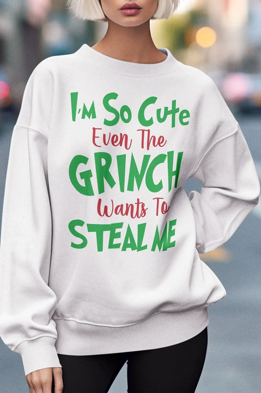 A cozy, oversized Christmas sweatshirt featuring a playful Grinch graphic with festive colors, perfect for winter wear.