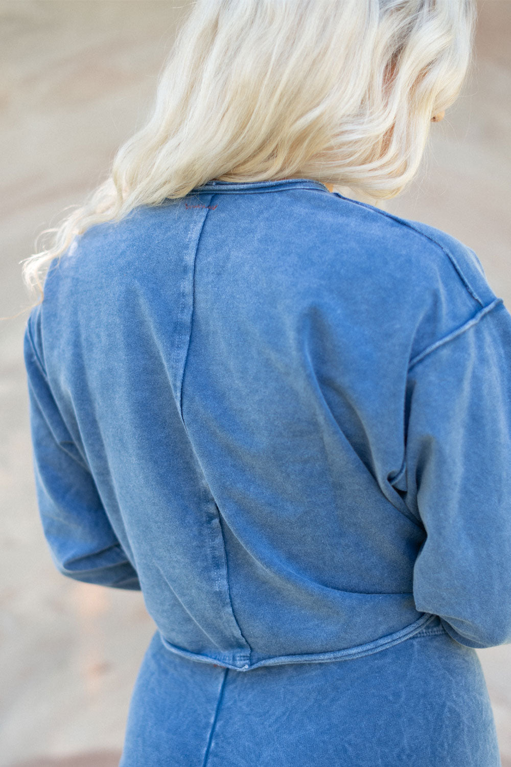 The Happiness Sweatshirt in washed black, showcasing its soft fabric and flattering fit, perfect for casual outings.