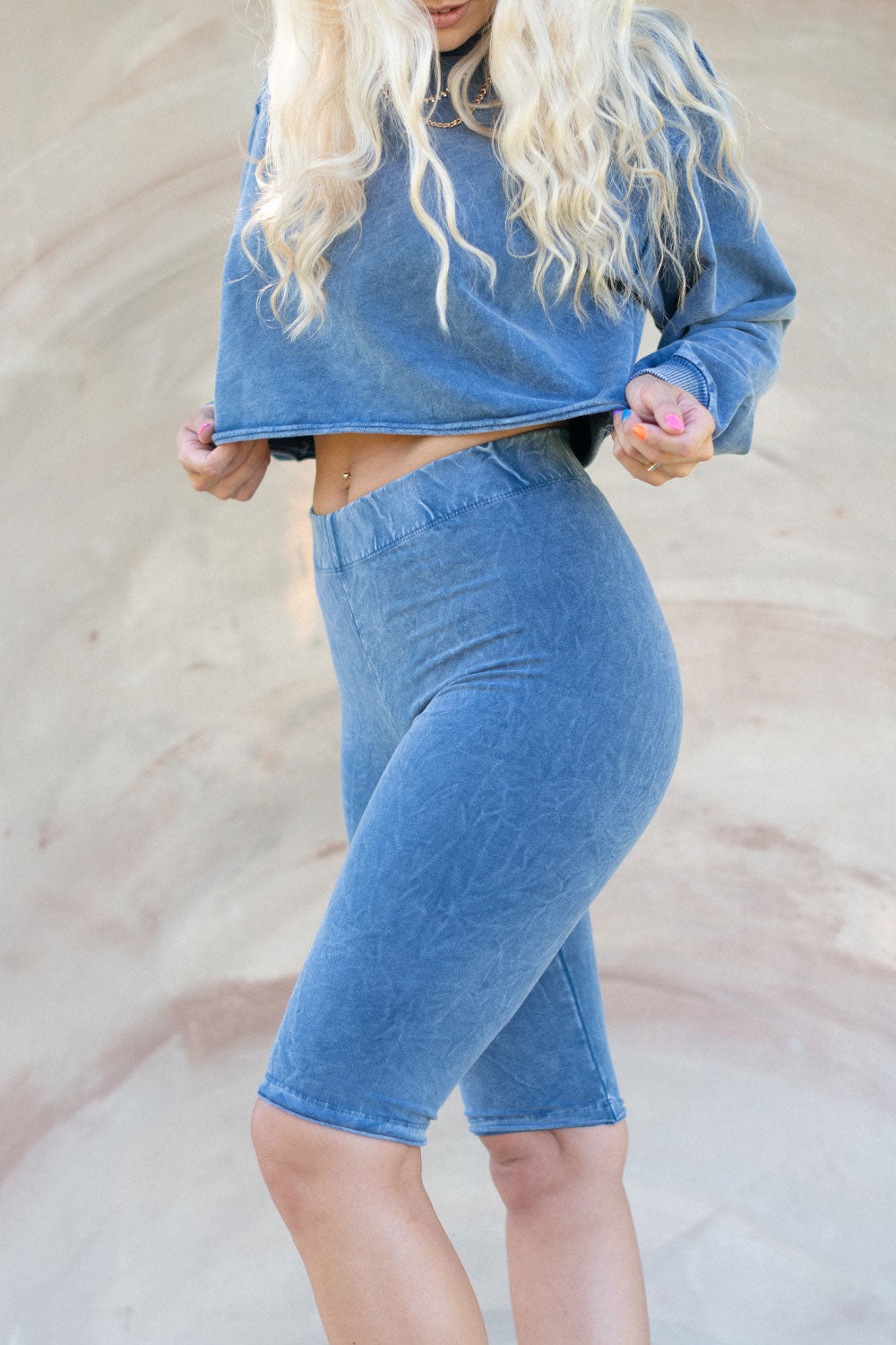 The Happiness Sweatshirt in washed black, showcasing its soft fabric and flattering fit, perfect for casual outings.