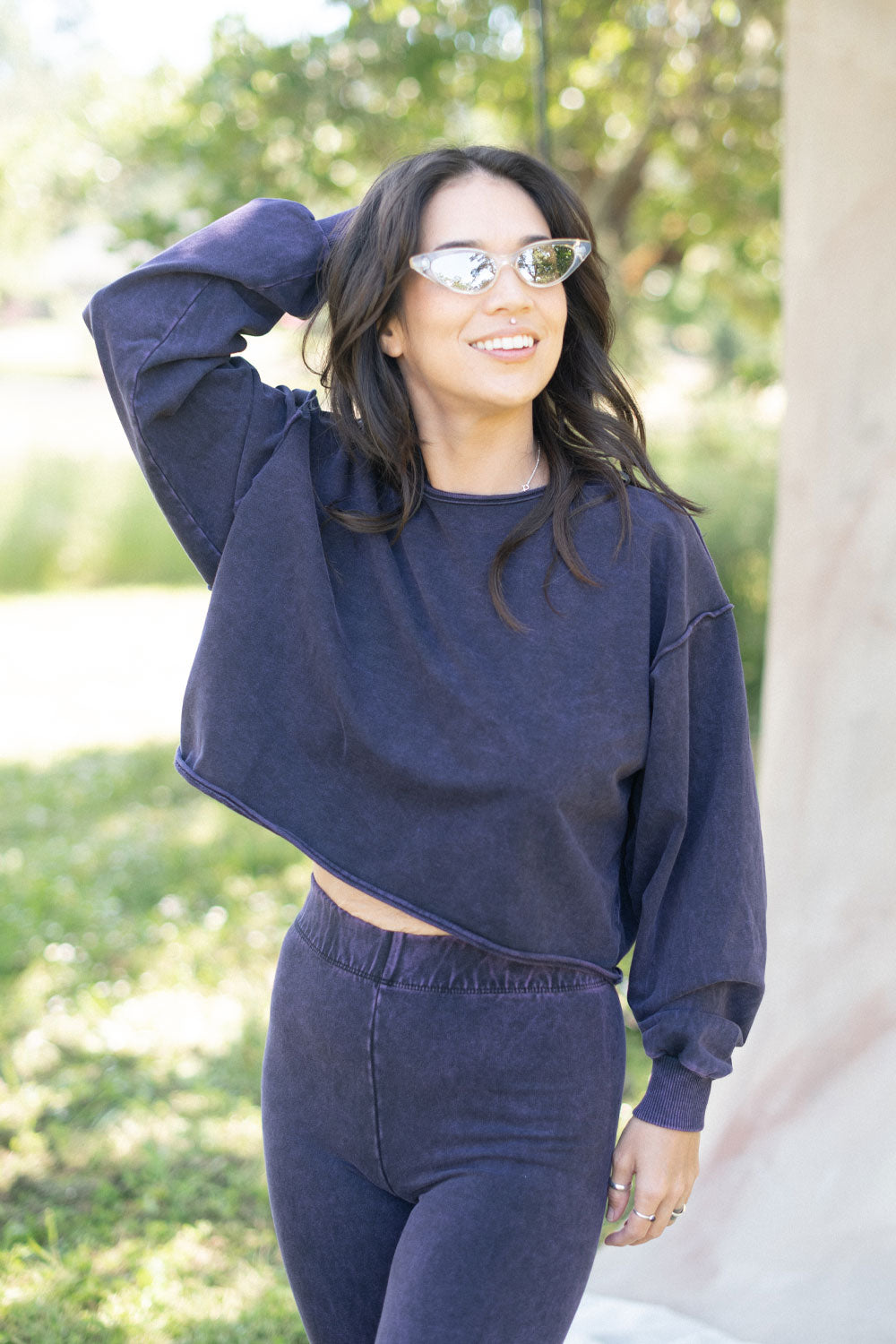 The Happiness Sweatshirt in washed black, showcasing its soft fabric and flattering fit, perfect for casual outings.