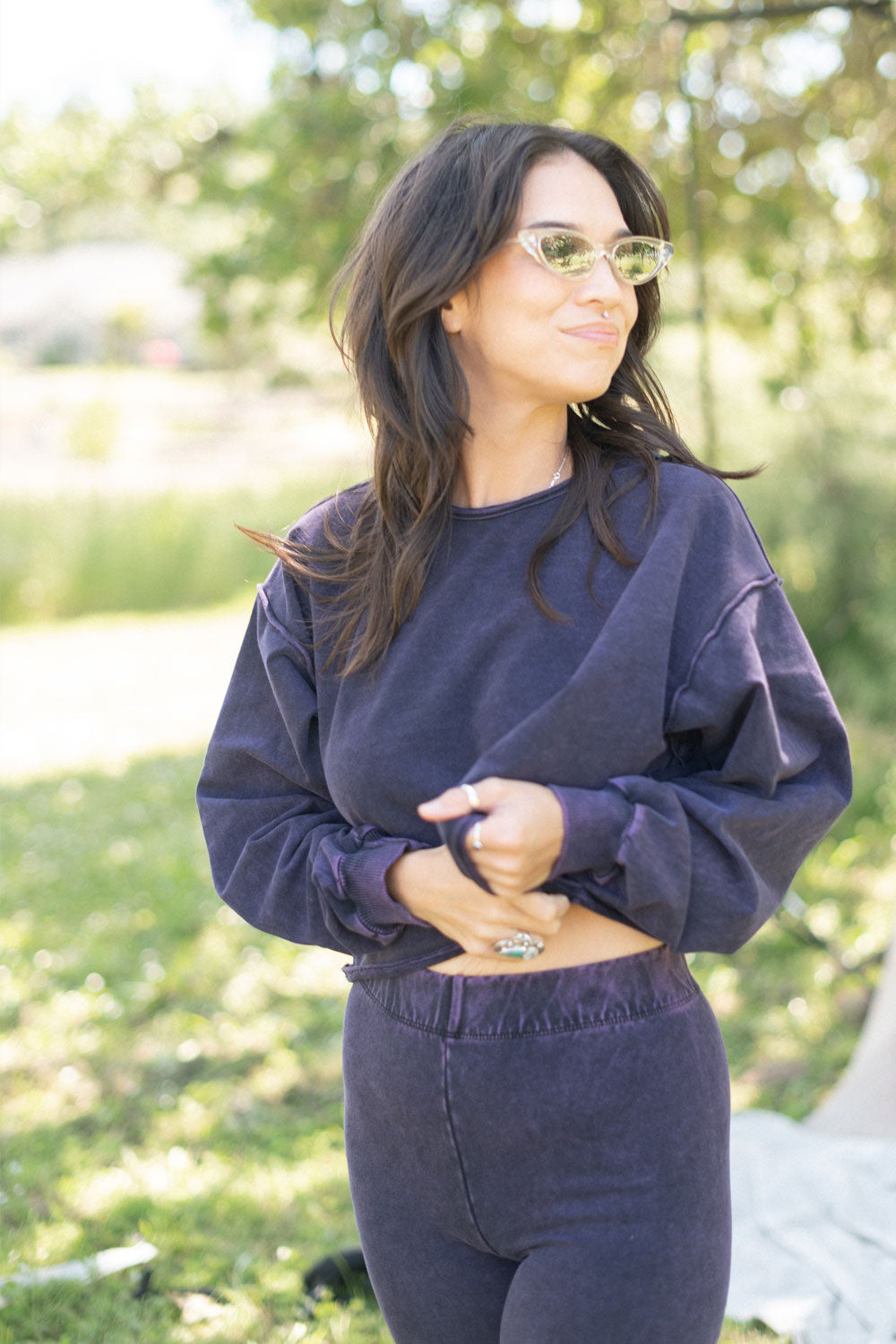 The Happiness Sweatshirt in washed black, showcasing its soft fabric and flattering fit, perfect for casual outings.