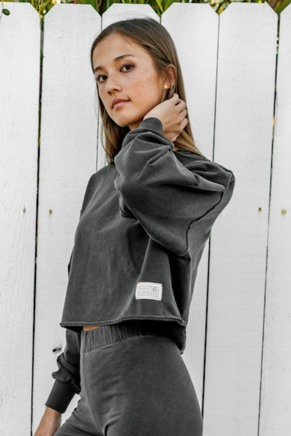 The Happiness Sweatshirt in washed black, showcasing its soft fabric and flattering fit, perfect for casual outings.