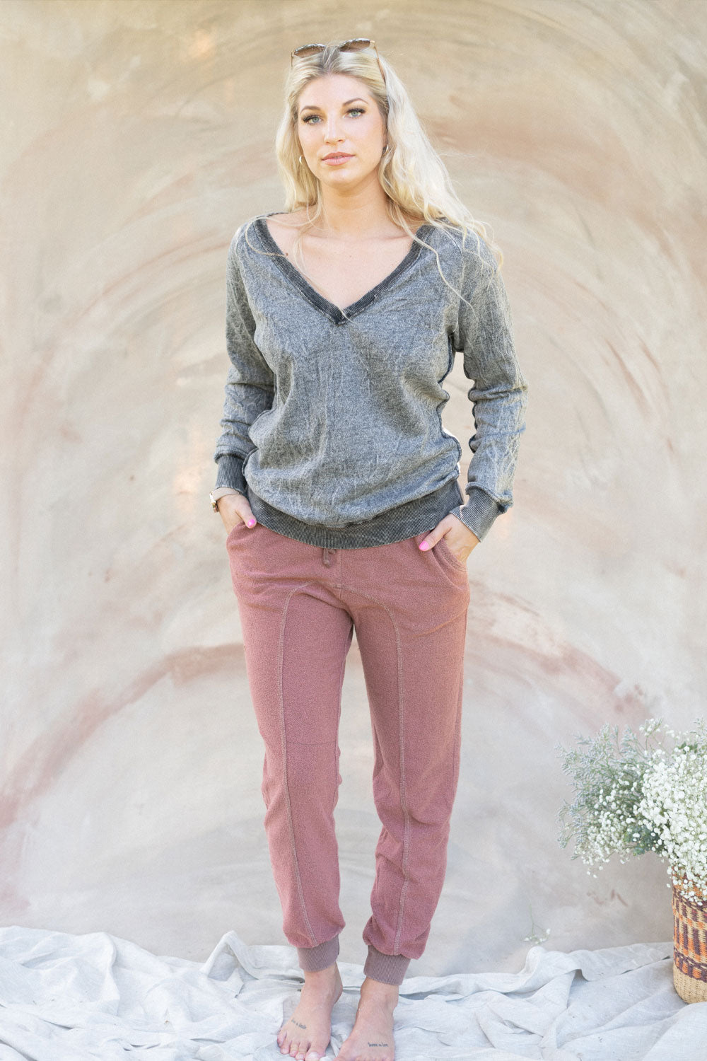 The Happy Sweater in Vintage Black, showcasing its stylish off-shoulder design and soft fabric, perfect for summer wear.