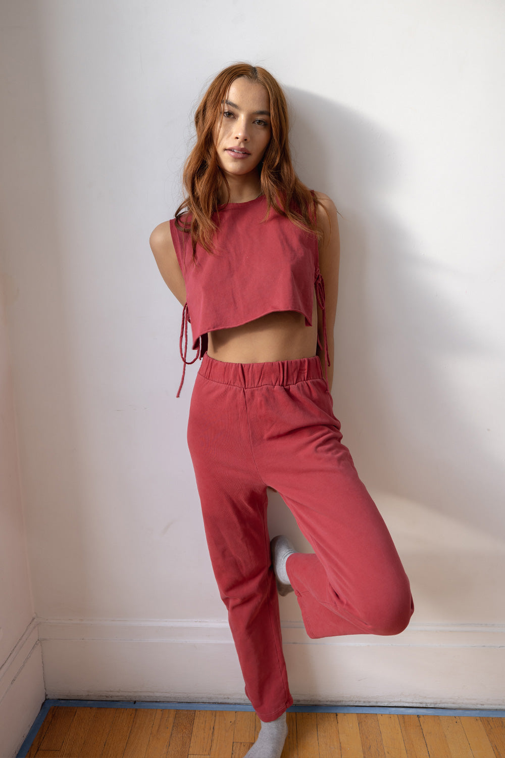 A pair of navy blue and maroon high-waisted leisure pants with an elastic waistband and slightly flared legs, made from organic cotton.