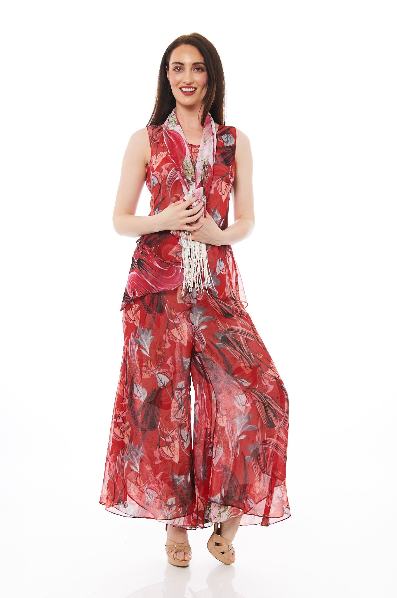A vibrant scarlet red reversible pant set displayed with a matching scarf, showcasing its versatile styling options.