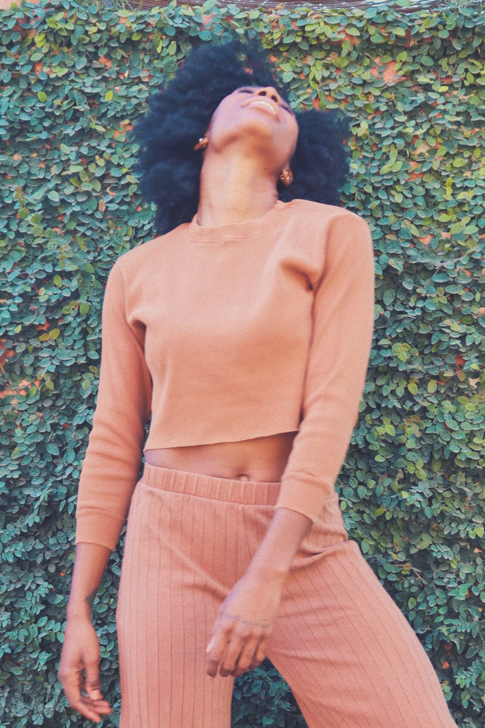 The Rib Top in saddle color, showcasing its loose yet fitting design with 3/4 sleeves, made from 100% organic cotton.