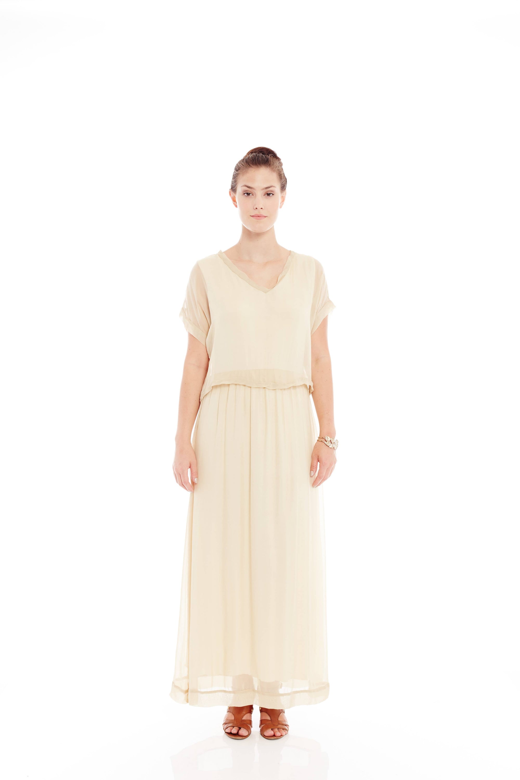 A beautiful beige maxi dress made of luxurious silk, showcasing a soft and gentle material, perfect for lounging or layering.