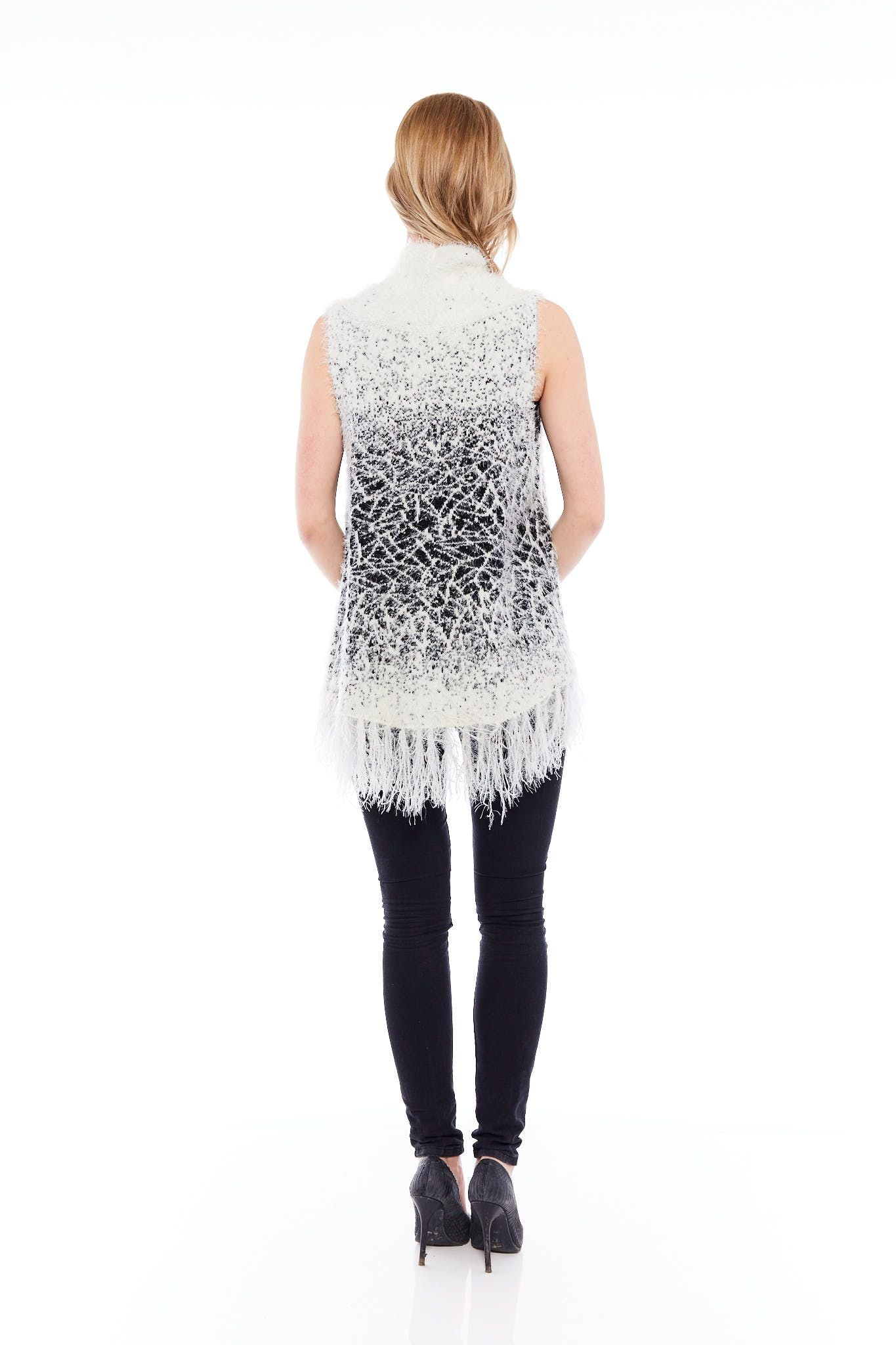 A cozy white winter sweater featuring tassel details, perfect for layering and stylish winter outfits.