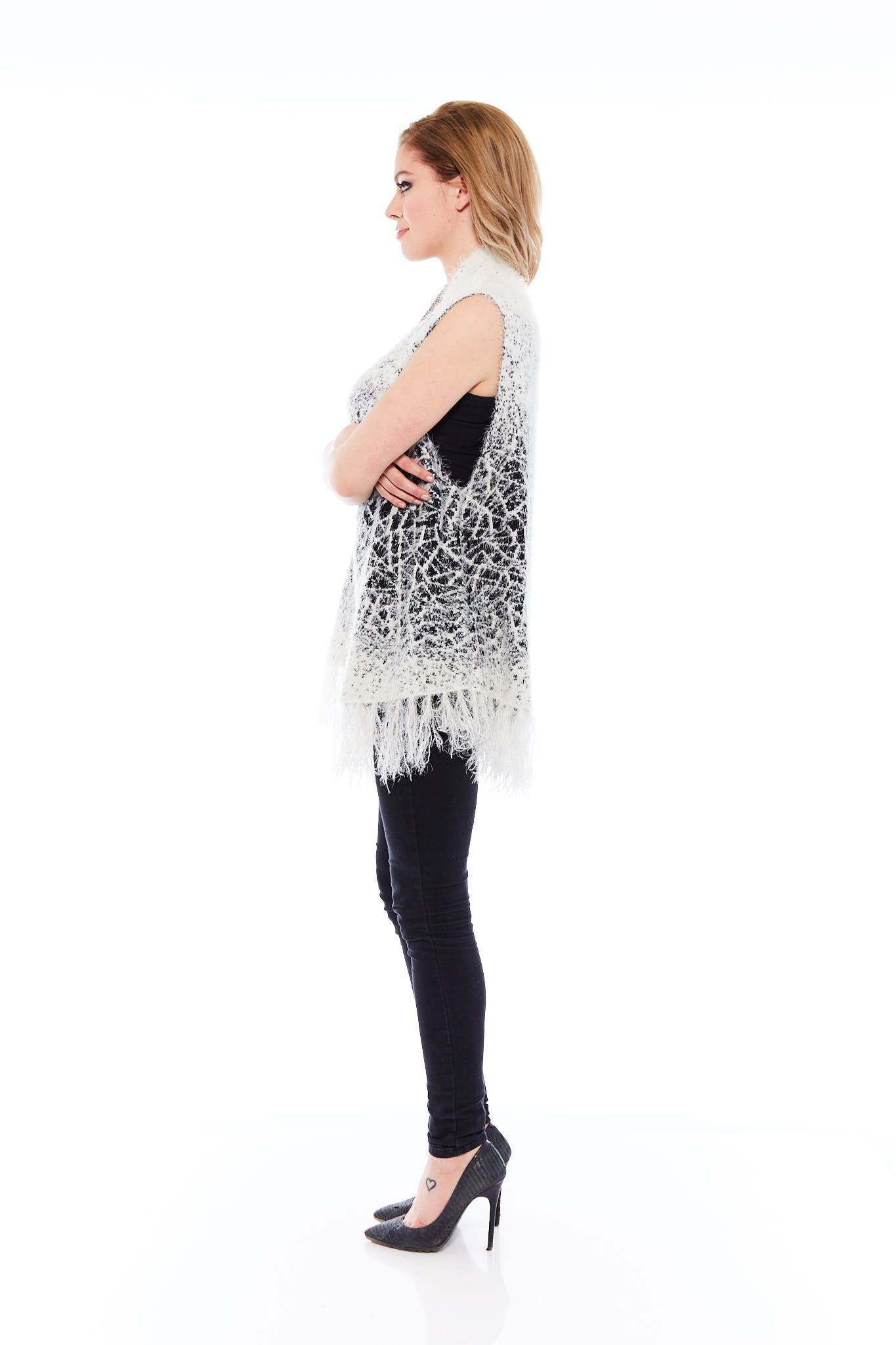 A cozy white winter sweater featuring tassel details, perfect for layering and stylish winter outfits.