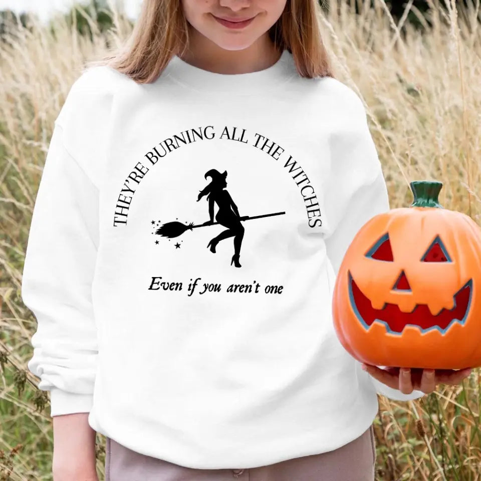 A stylish Halloween top featuring the phrase 'They're Burning All The Witches I Did Something Bad', designed for comfort and style.