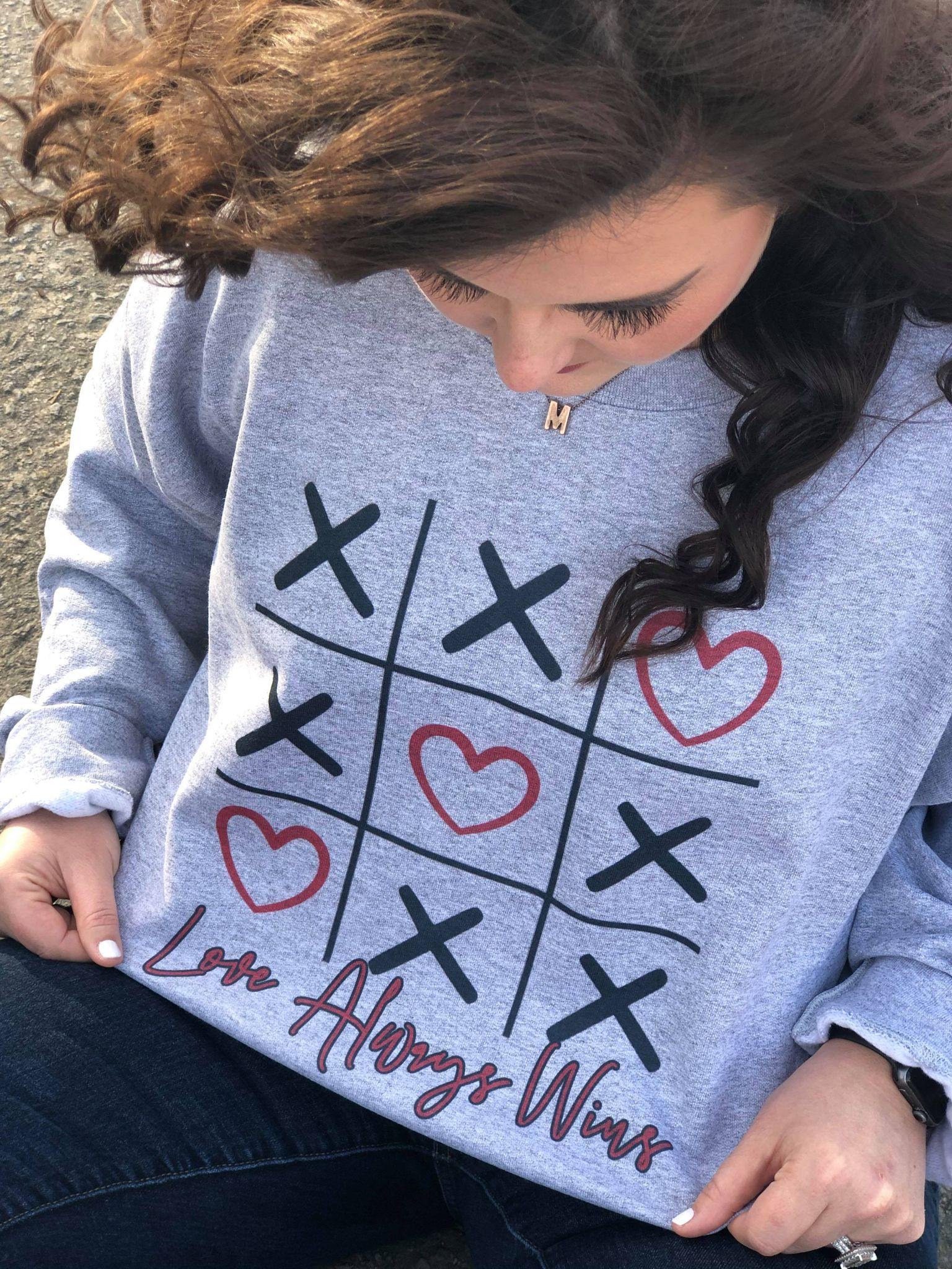 A cozy Tic Tac LOVE Sweatshirt featuring a playful love-themed design, perfect for casual wear.