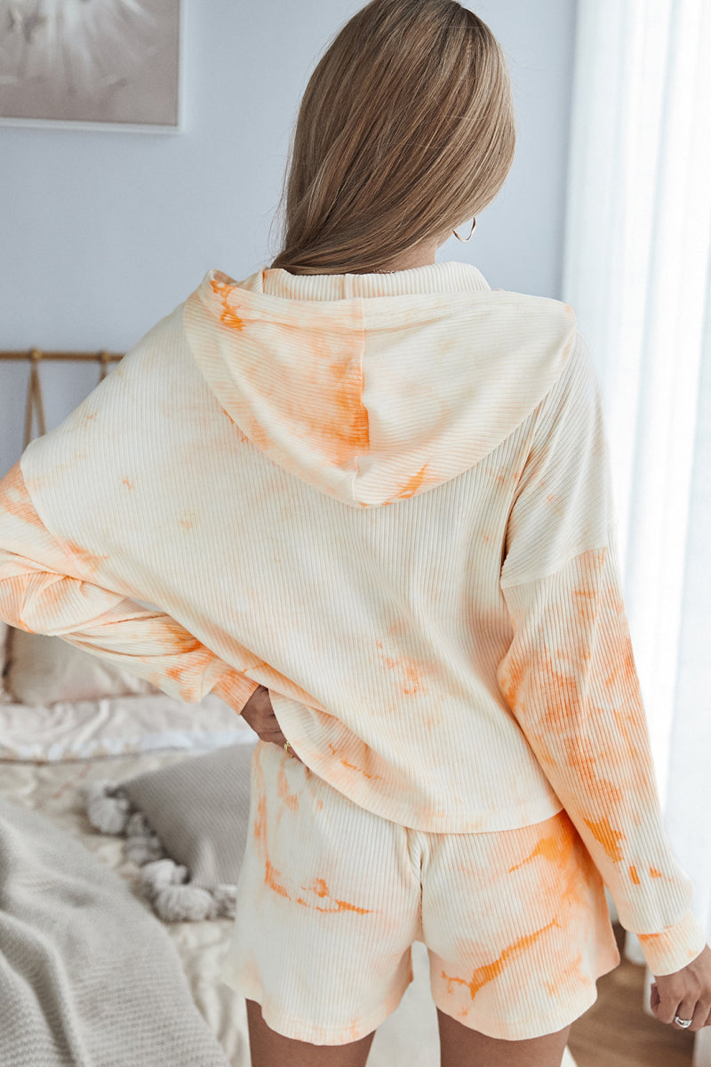 A stylish tie dye hoodie and shorts lounge set featuring a long sleeve hoodie and high waist shorts, perfect for casual wear.