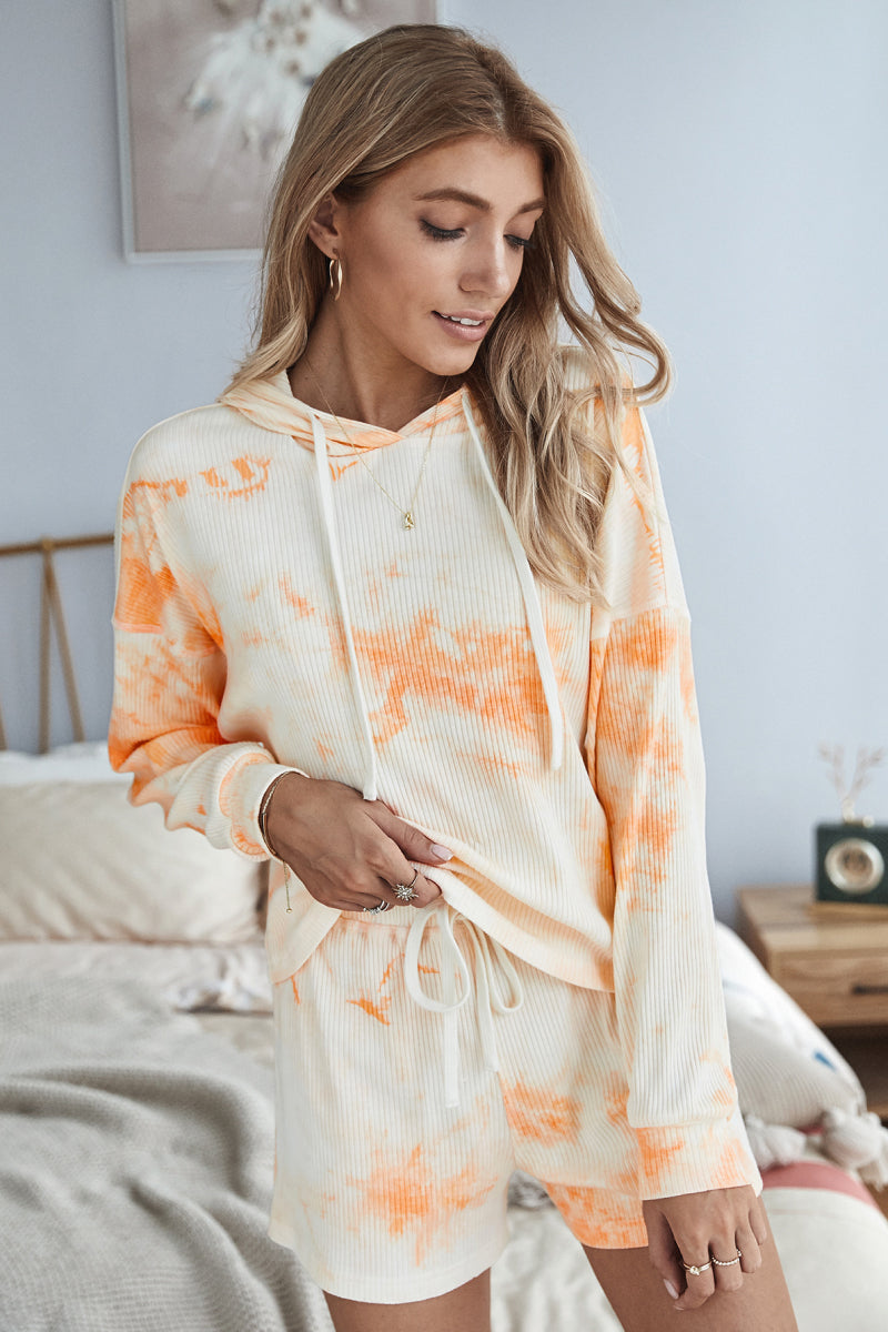 A stylish tie dye hoodie and shorts lounge set featuring a long sleeve hoodie and high waist shorts, perfect for casual wear.