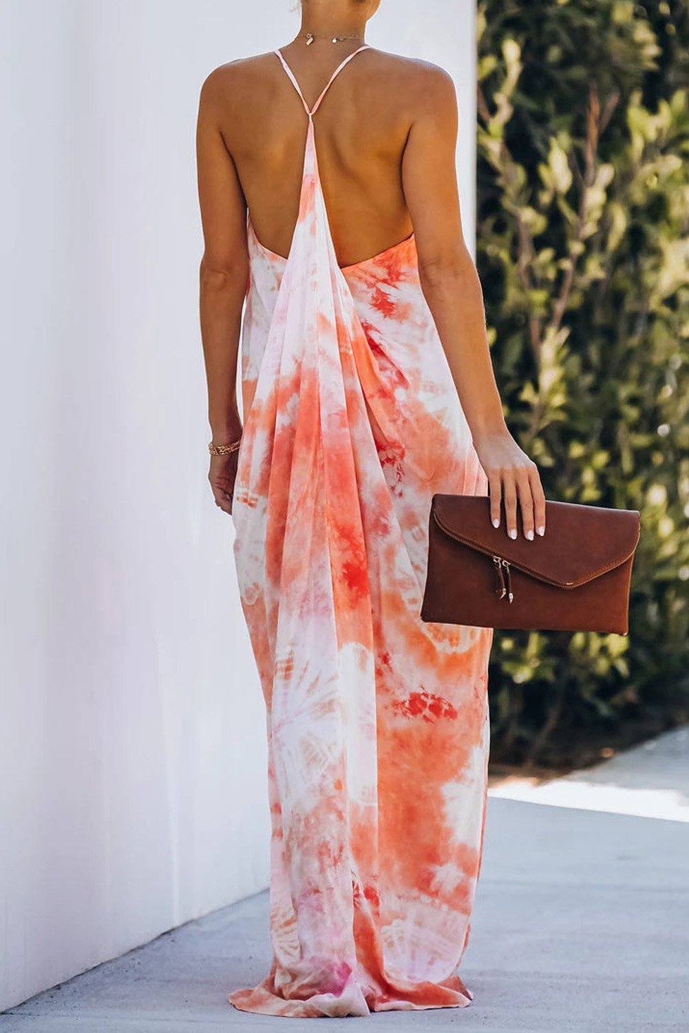 A stylish tie-dye drape maxi dress featuring a v-neckline and t-strap back, showcasing vibrant colors and an elegant silhouette.