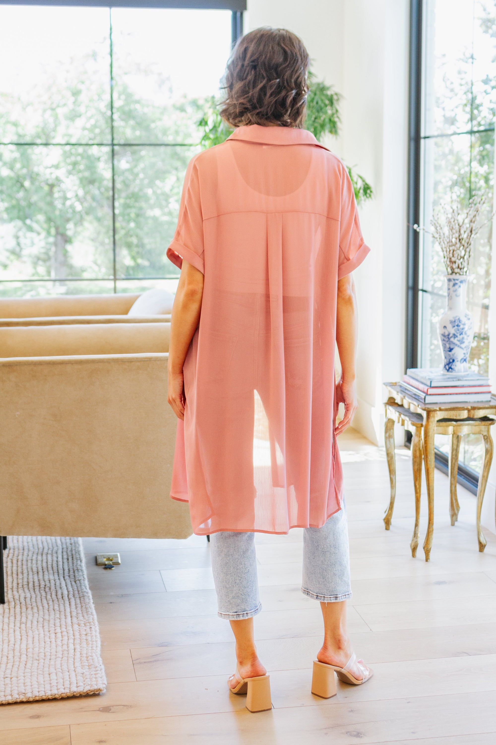 A stylish Timeless Appeal Shirtdress in sheer poly chiffon, featuring a collared design, button front, and side slits, perfect for any occasion.