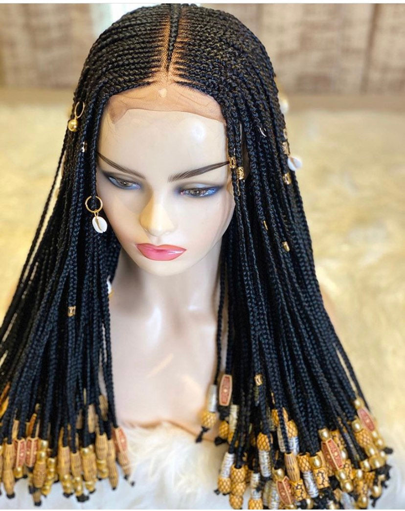 Tinsley Wig featuring intricate braids adorned with beads and cowries, showcasing a full closure design for a natural look.