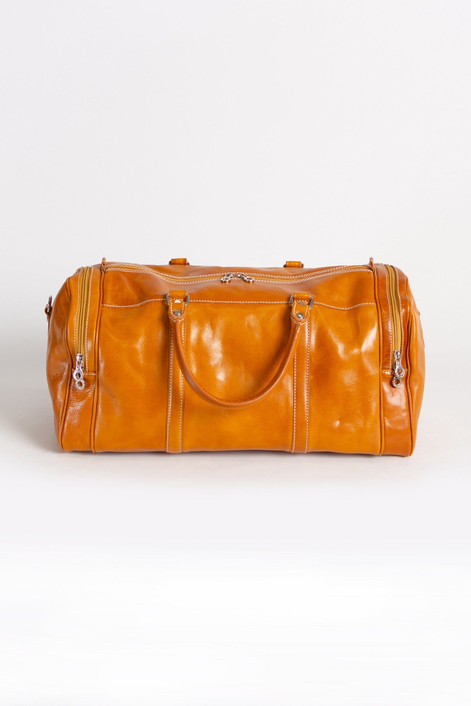 Elegantna svetlo rjava torba iz naravnega usnja Ava, ročno izdelana v Firencah, z več predali in kovinskimi zadrgami.