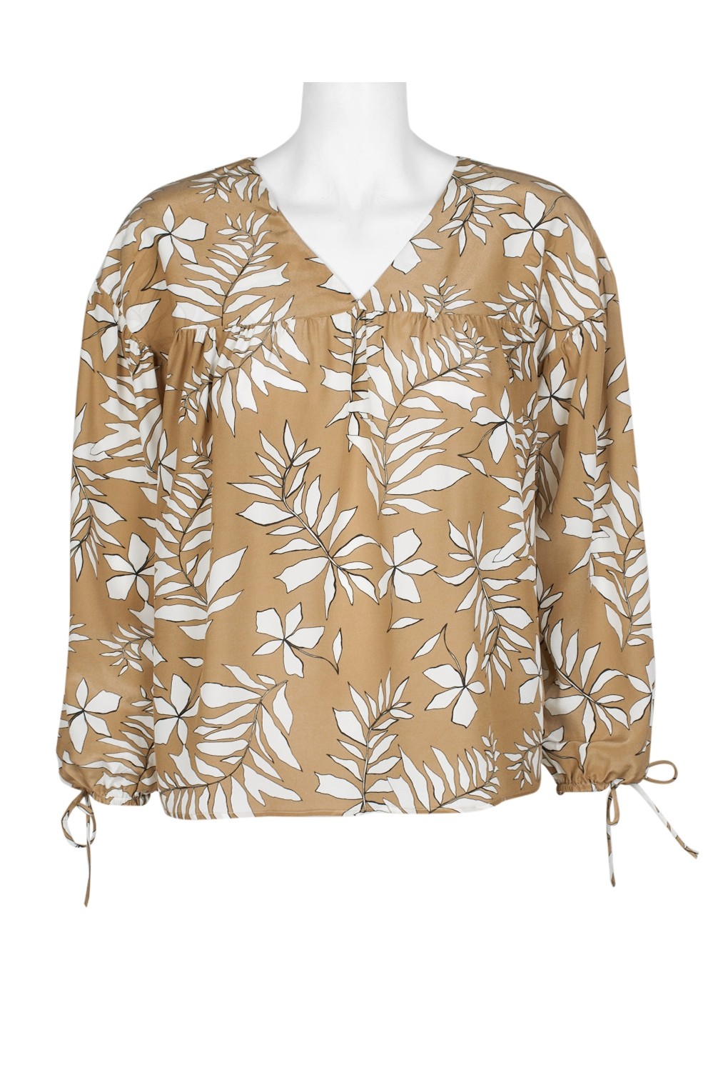 Tan blouse with white floral pattern.