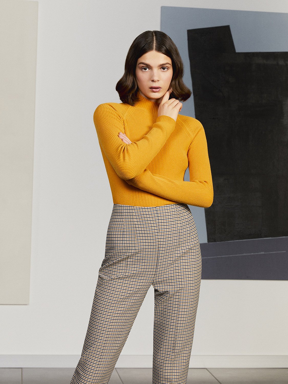A cozy turtleneck knit sweater in bright hues, featuring long sleeves and a soft texture, perfect for casual wear.
