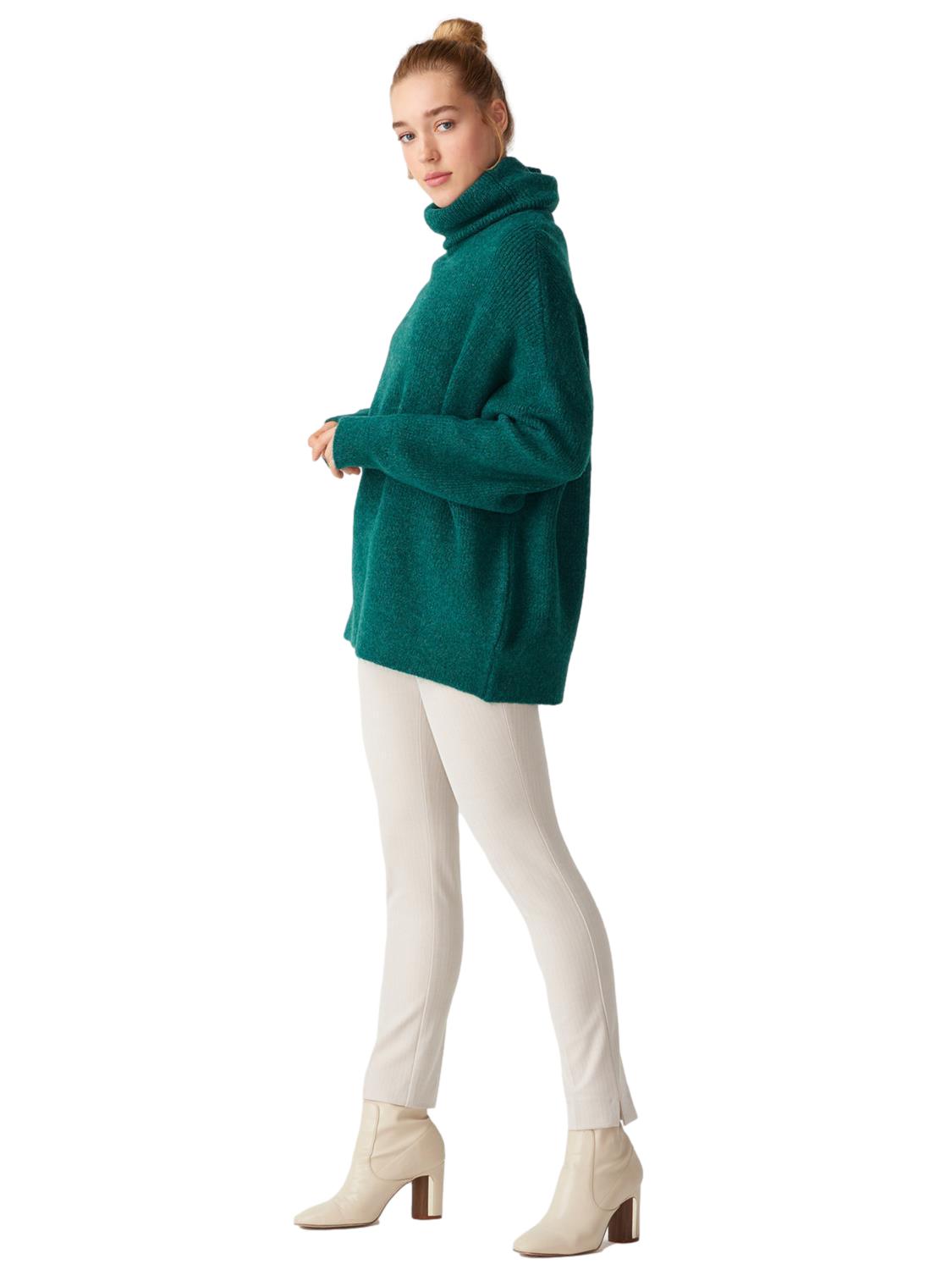 A cozy Turtleneck Wide Sweater in a soft acrylic-polyester blend, featuring a relaxed fit and stylish turtleneck design.