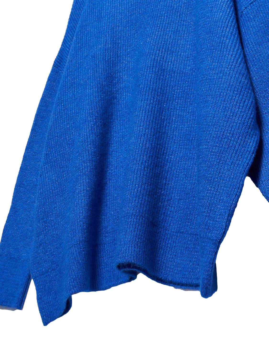 A cozy Turtleneck Wide Sweater in a soft acrylic-polyester blend, featuring a relaxed fit and stylish turtleneck design.