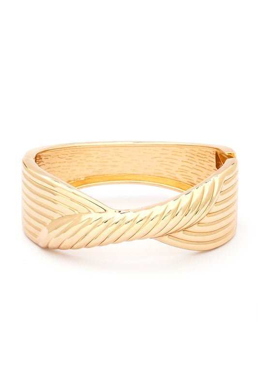 Twisted Designed Hinged Bangle in 18 KT gold plating with a unique twisted pattern and spring hinged closure.
