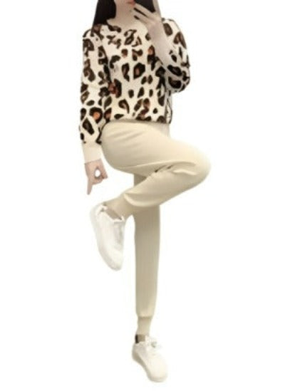 Two-piece casual knitted outfit featuring long-sleeved pullover and elastic waist pants in leopard print.