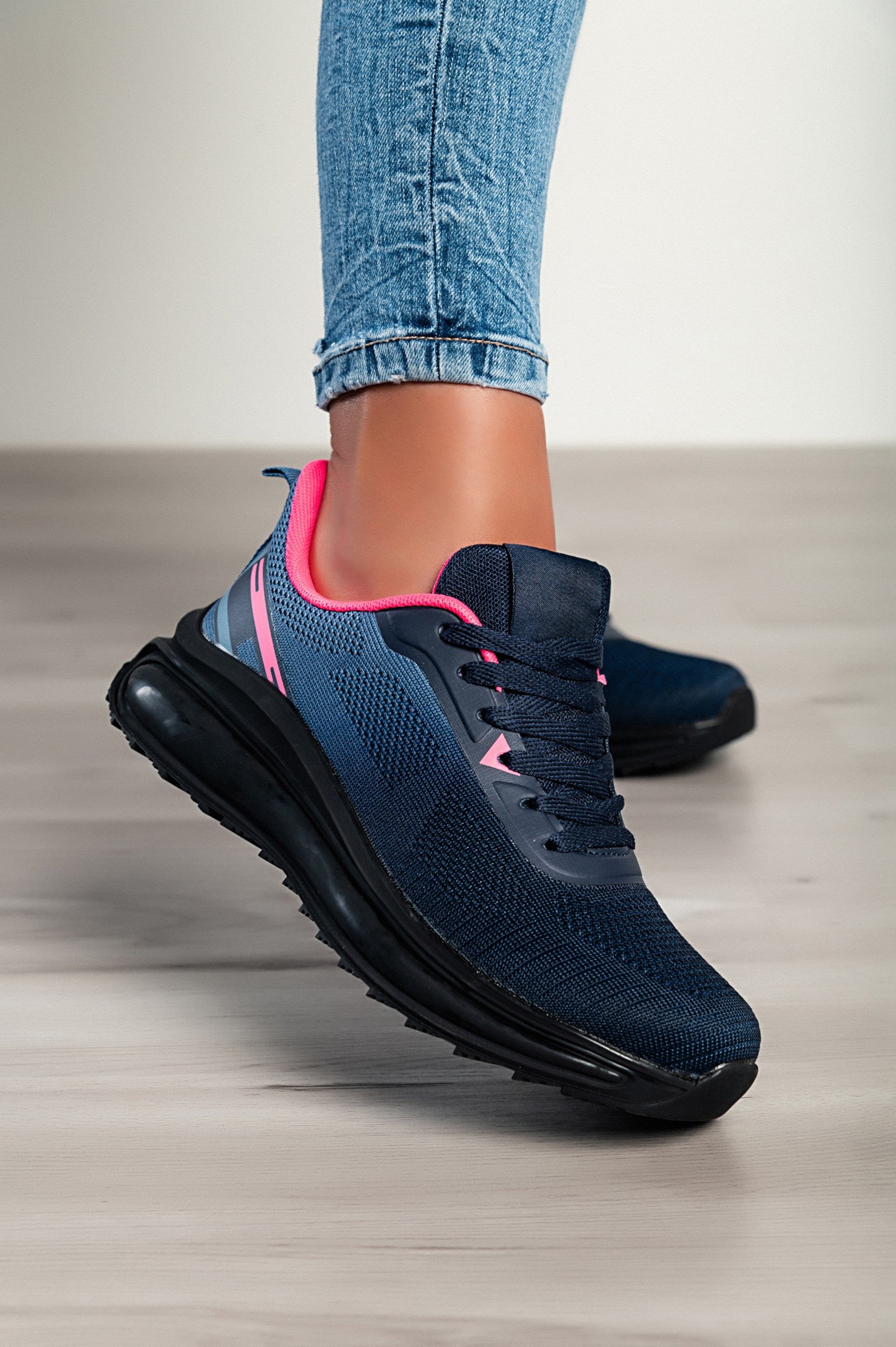Stylish two-tone blue sneakers with a textile upper, reinforced heel and toe, and lace-up closure.