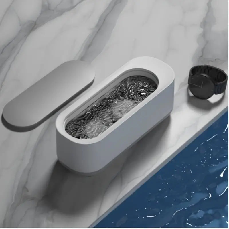 Portable ultrasonic cleaner machine designed for effective jewelry and eyeglass cleaning with high-frequency vibrations.