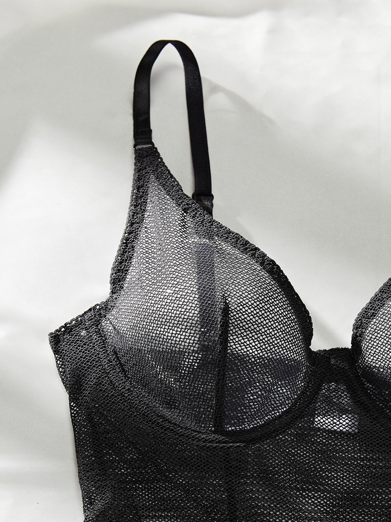 A sexy sleeveless mesh bodysuit featuring lace and tulle splicing, perfect for summer wear.