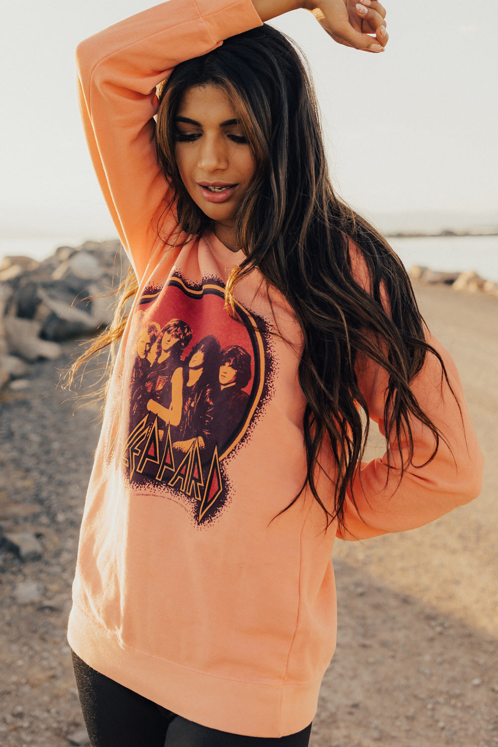 Upcycle Def Leppard School Sweater in peach color, featuring the iconic band logo, made from 100% cotton with eco-friendly dye.
