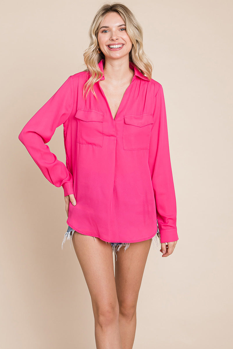 A stylish V neck collared blouse with two front pockets, featuring long sleeves and a button front, displayed on a mannequin.