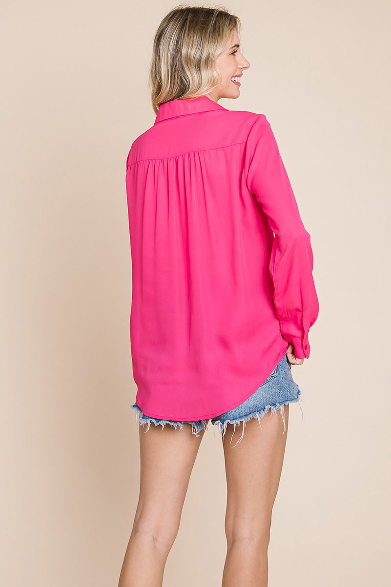 A stylish V neck collared blouse with two front pockets, featuring long sleeves and a button front, displayed on a mannequin.