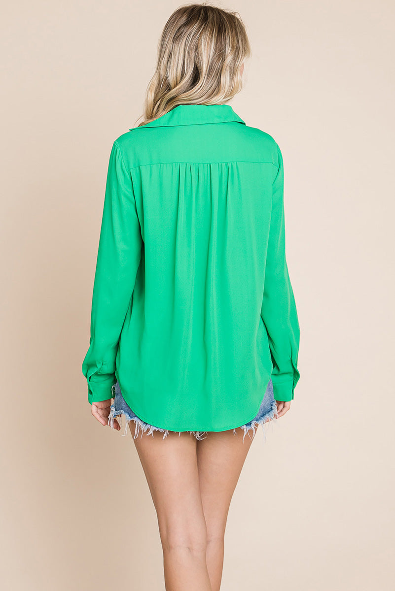 A stylish V neck collared blouse with two front pockets, featuring long sleeves and a button front, displayed on a mannequin.